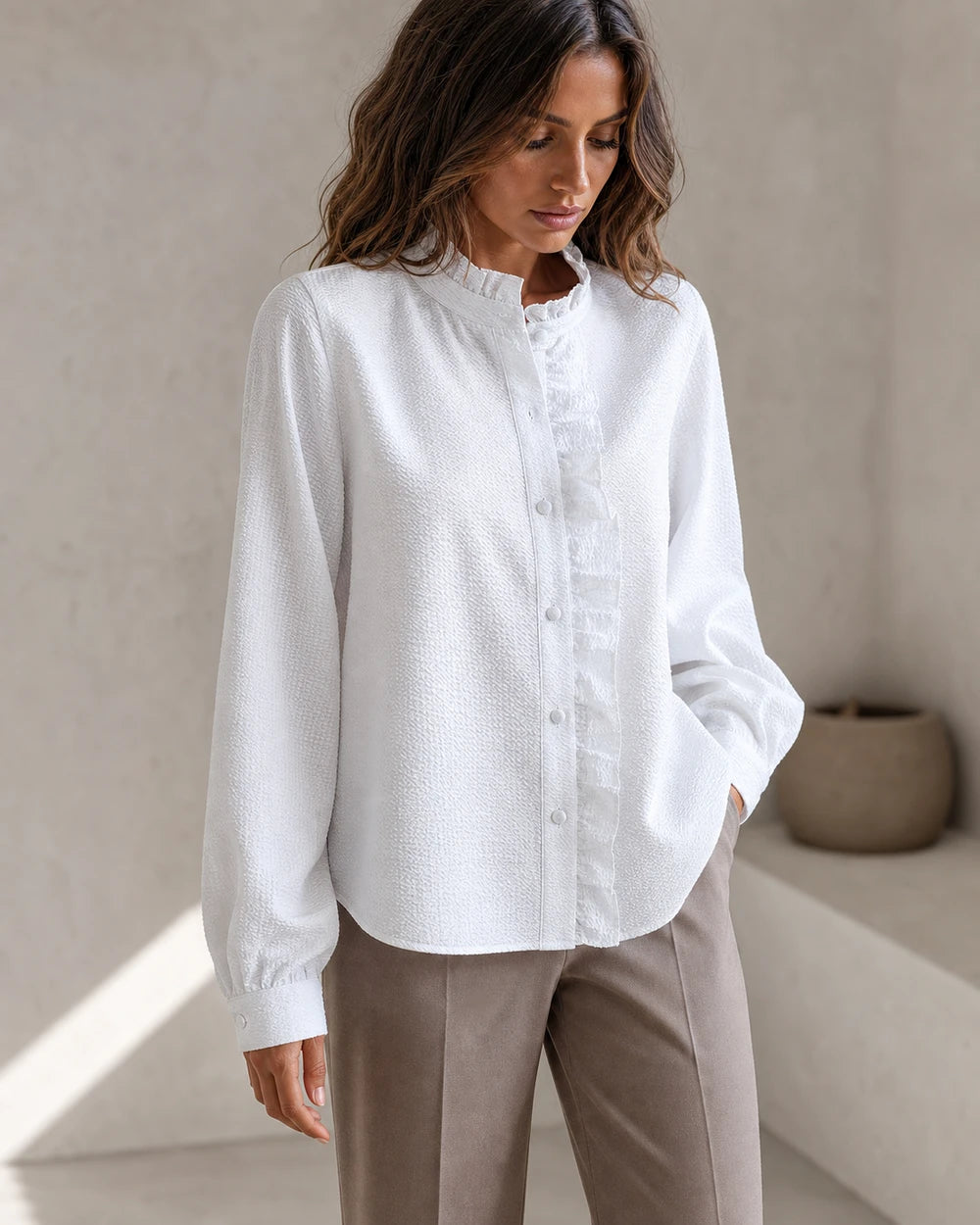 Women's white ruffle-trim blouse, front product view.