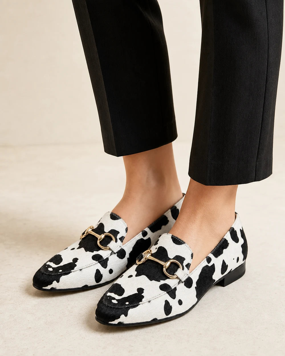 Octavia | Western Cow Print Buckle Flat Loafers — loafers-for-women-animal-print-slip-on-black-white-01-worn-hero.webp