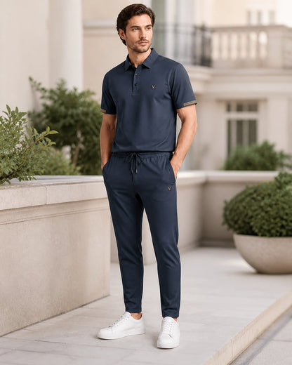 Blue men's polo and trousers set in a modern terrace setting.