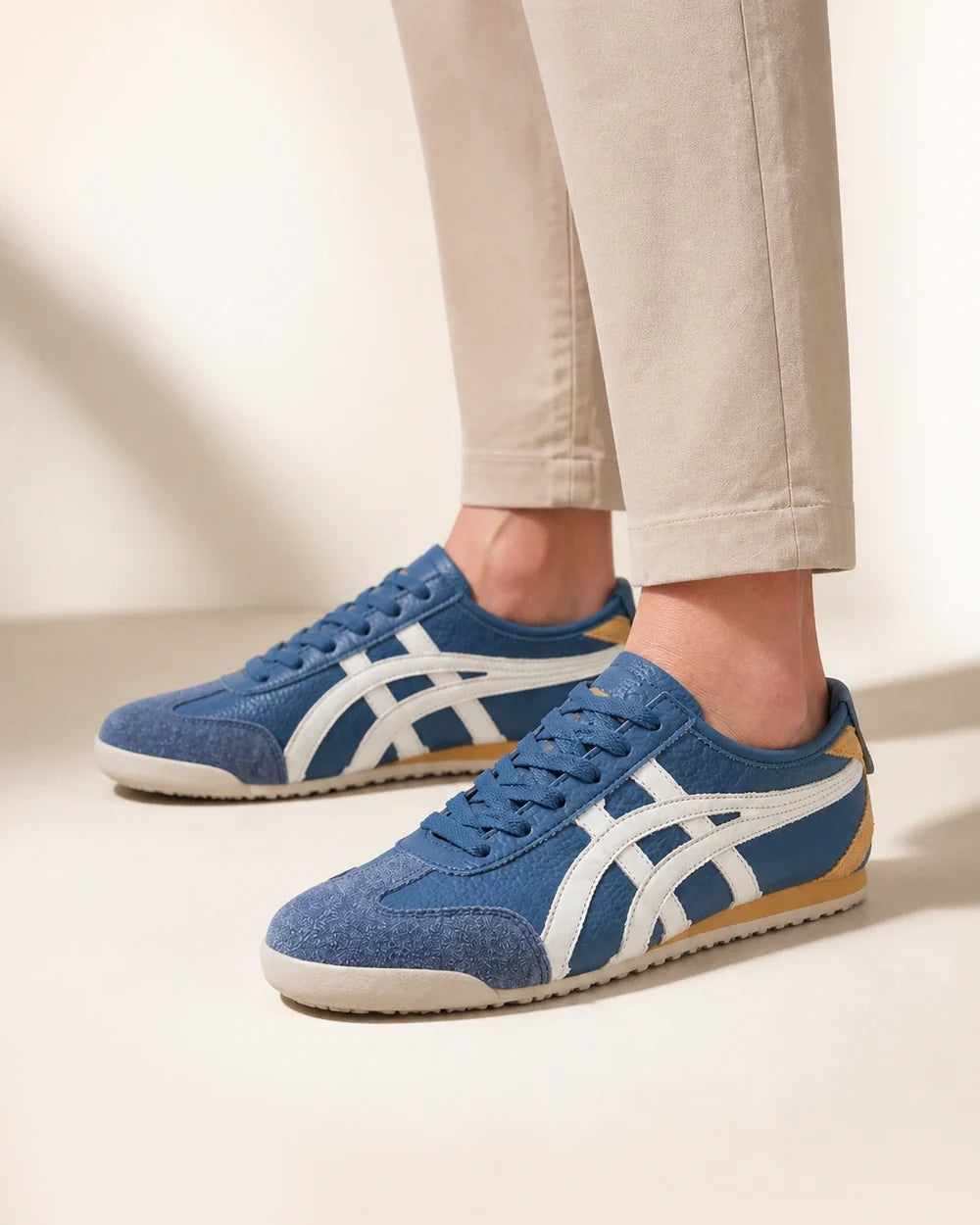 Men wearing blue retro panel sneakers, close product-first view.